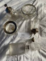 A collection of silver topped bottles, bowls and sugar sifter