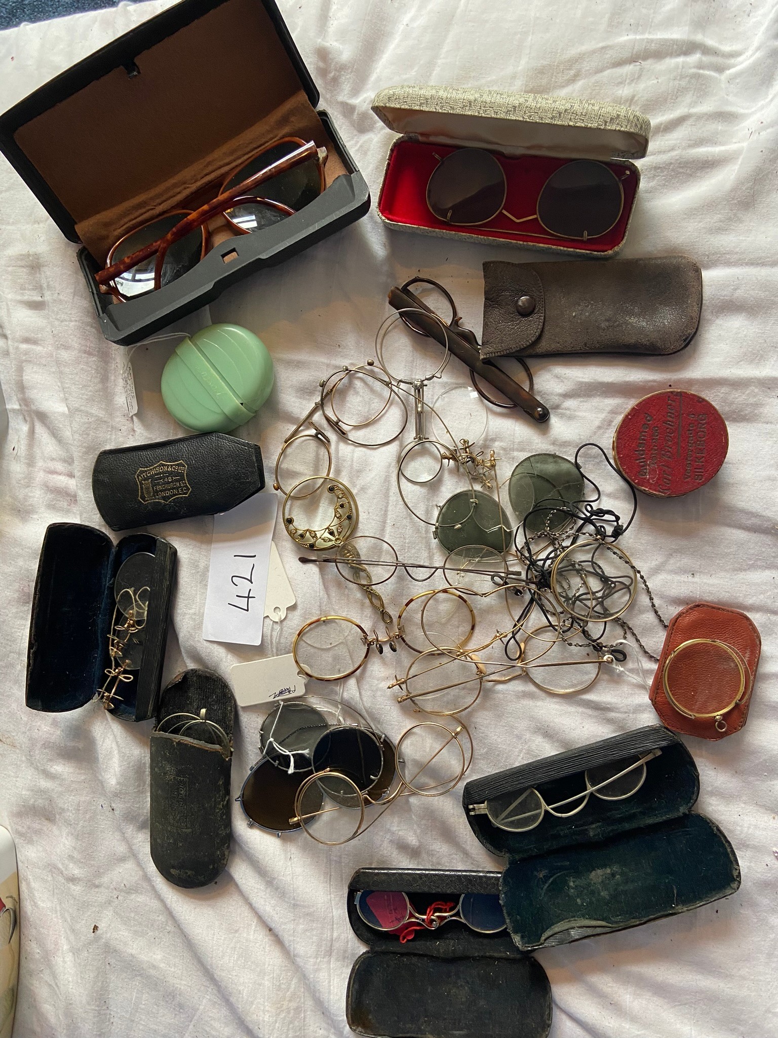 A collection of glasses including monocles, lunettes and cases etc