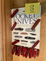 15 Swiss Army knives and a pocket knife book