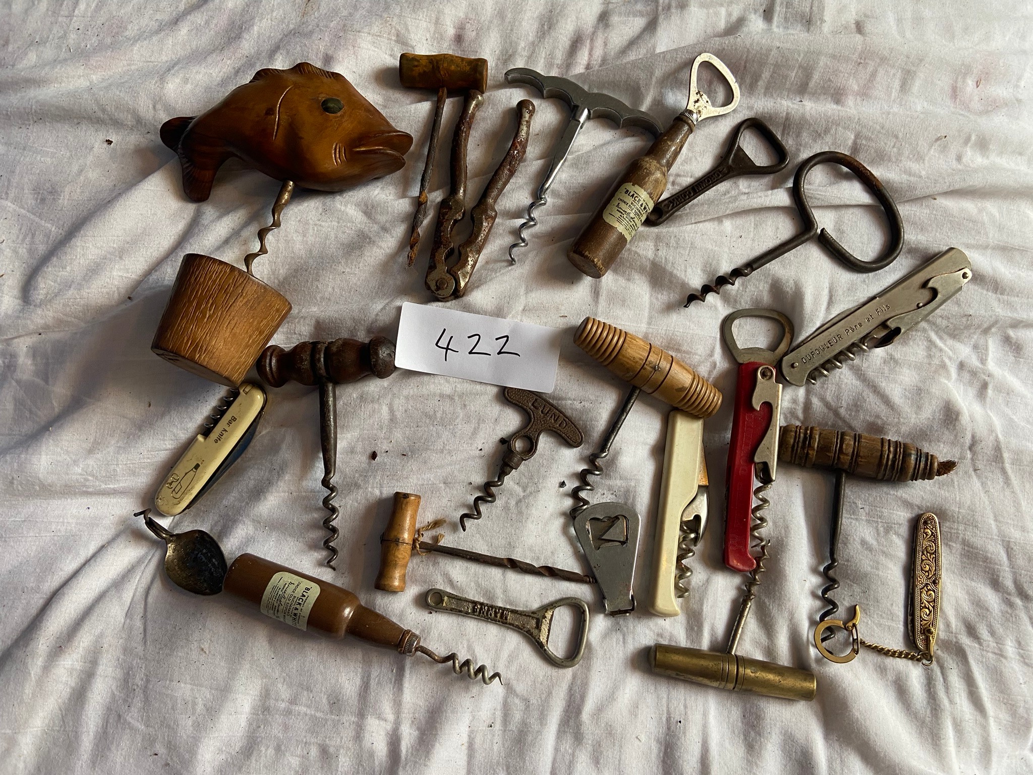 A collection of corkscrews, knives and bottle openers