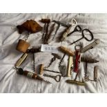 A collection of corkscrews, knives and bottle openers