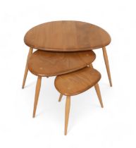 A nest of three Ercol blonde elm pebble side tables, model 354, largest table 66 by 45 by 40.5cm