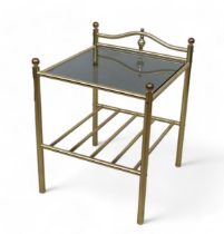 A brass and black glass topped square side table