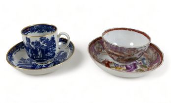 A first period Worcester blue and white tea cup and saucer and a famille rose tea bowl and saucer.