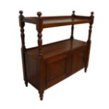 An Edwardian mahogany buffet, two shelves, twin cupboard below, raised on turned feet.