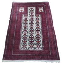A 20th century woollen Baluch prayer rug, with caucasian ground centre and red ground borders, 145