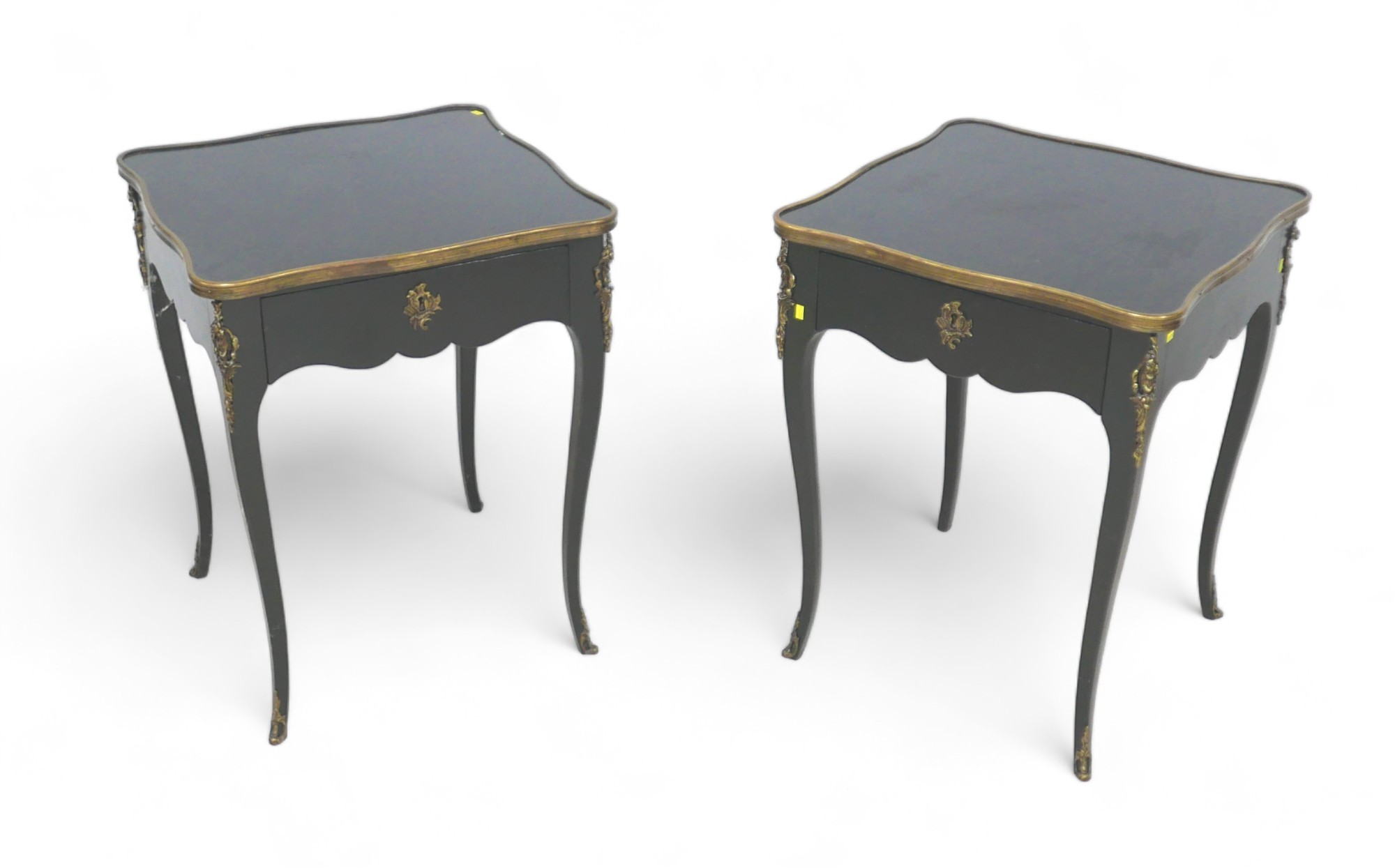 A pair of French, early 20th century ebonised side tables, the square surfaces with serpentine brass