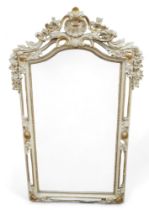 A French style gilt and cream wall mirror, with arch top, shell detail.