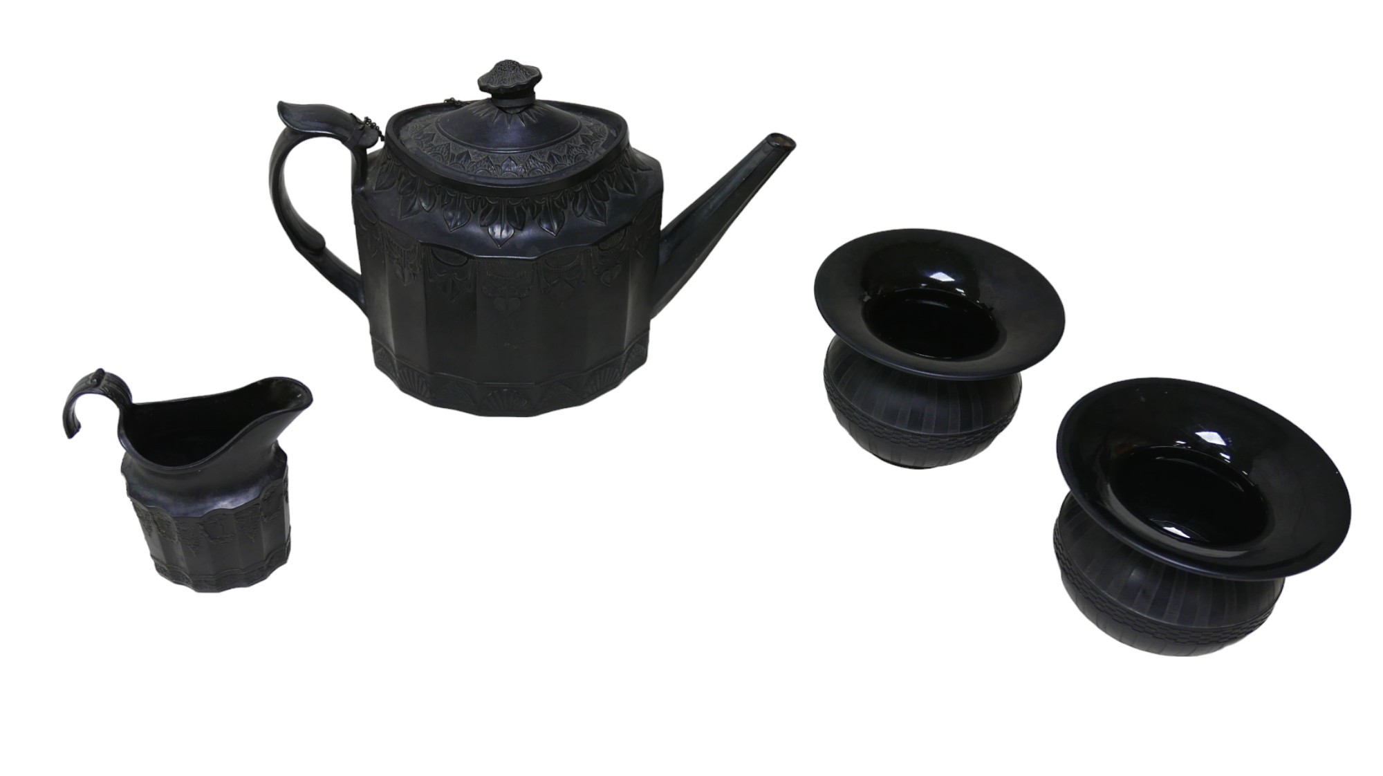 Four pieces of basalt wares, comprising a teapot, 27 by 11.5 by 18cm high, and milk jug, 10.5 by 5.3