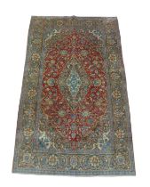 A Kashan rug, on red ground, with central diamond medallion, with pendant anchors, with large