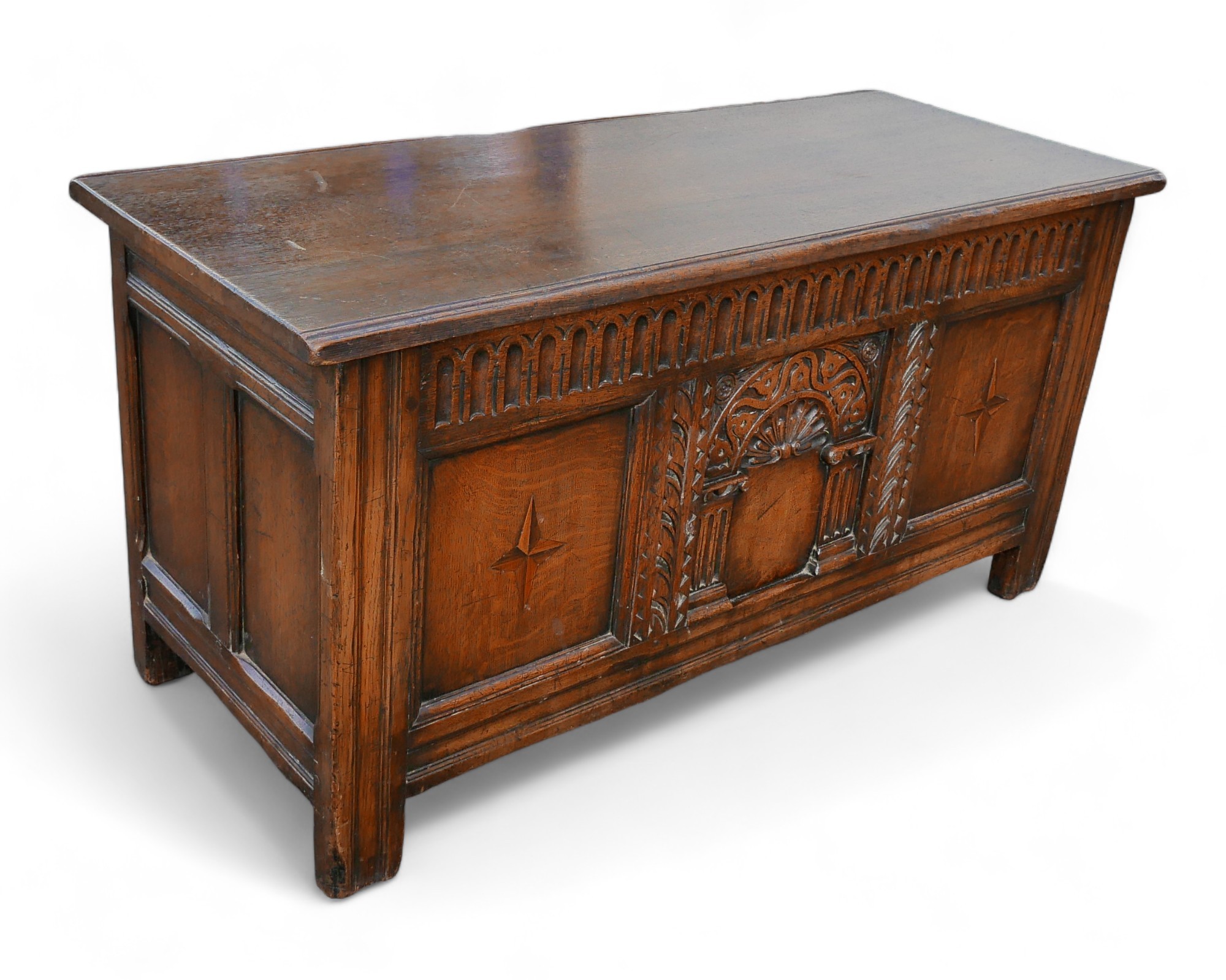 A mid 20th century stained oak chest, labelled 'Inglesants, Furnishers of Leicester', carved arch