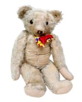 A vintage mohair Hygienic merrythought teddy bear, button to ear, 66cm tall. In worn, loved