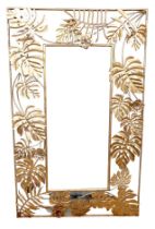 A modern brass effect mirror, with cheese plant leaf border, rectangular.