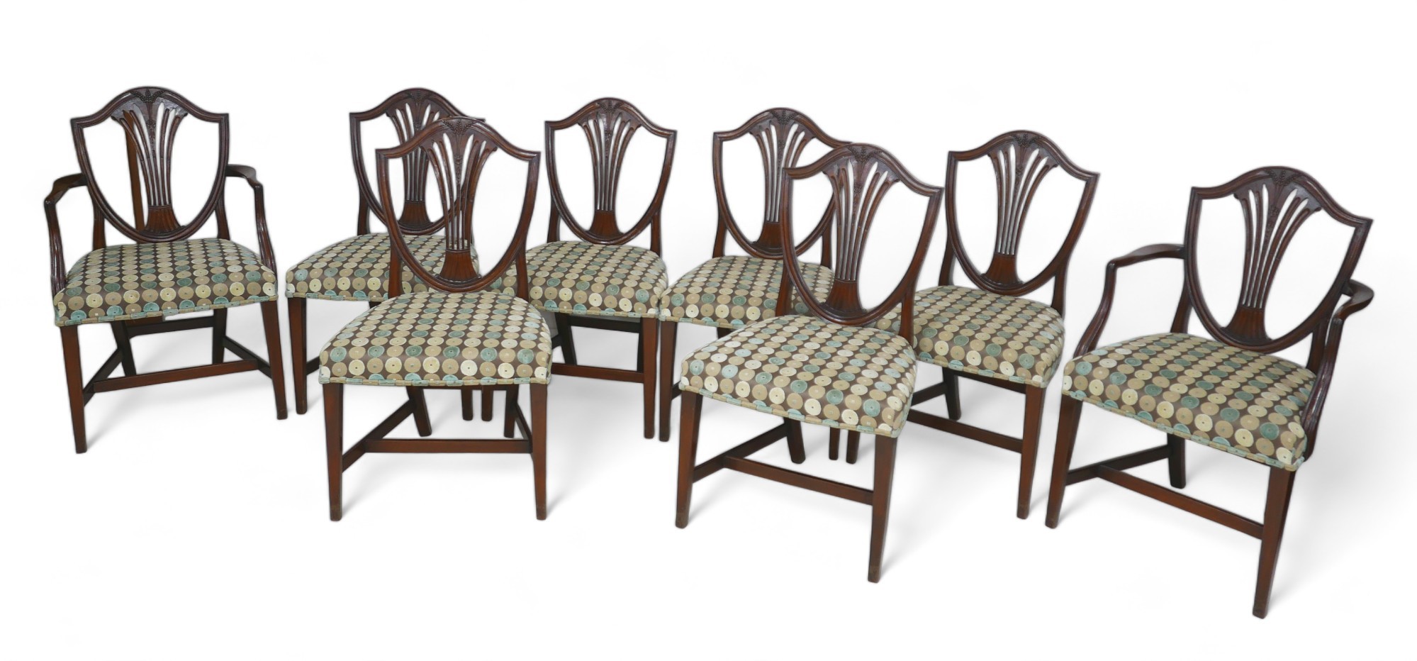 A set of eight mahogany dining chairs in the Georgian taste, with overstuffed seats, including two