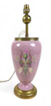 An early 20th century china table lamp, of vase form decorated with a floral spray against a pink