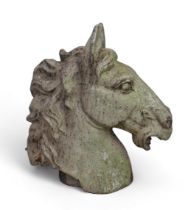 A cast metal model of a horse’s head, ears up.