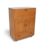 An Ercol blonde elm drinks cabinet, with a fall front above two cupboard doors and a drawer, 82.5 by