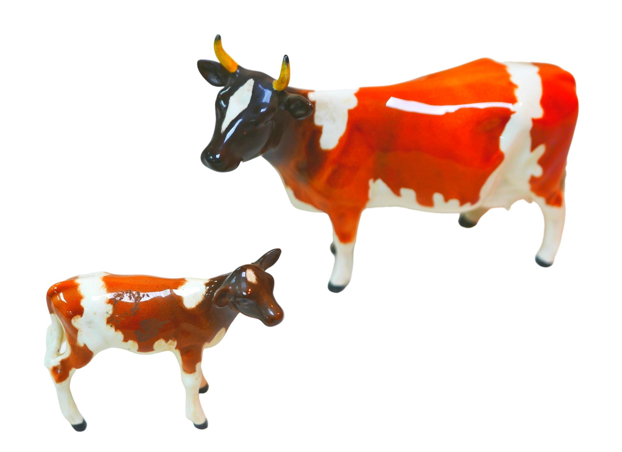 Two Beswick figurines of cattle, comprising a Ayreshire cow, 'Ch. Ickham Bessie', 11.5cm high, a