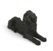 A cast iron sculpture, modelled as a recumbent lion, 2.9kg, 27 by 8 by 14.5cm high.