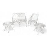 A white metal garden seat, chair, and two small matching tables, all with quatrefoil details. (4)