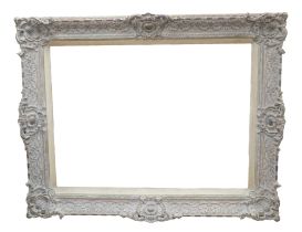 A large rectangular framed mirror, with ornate plaster frame,