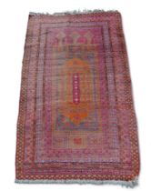 A small part silk rug, on red ground, orange central medallion and multiple borders.