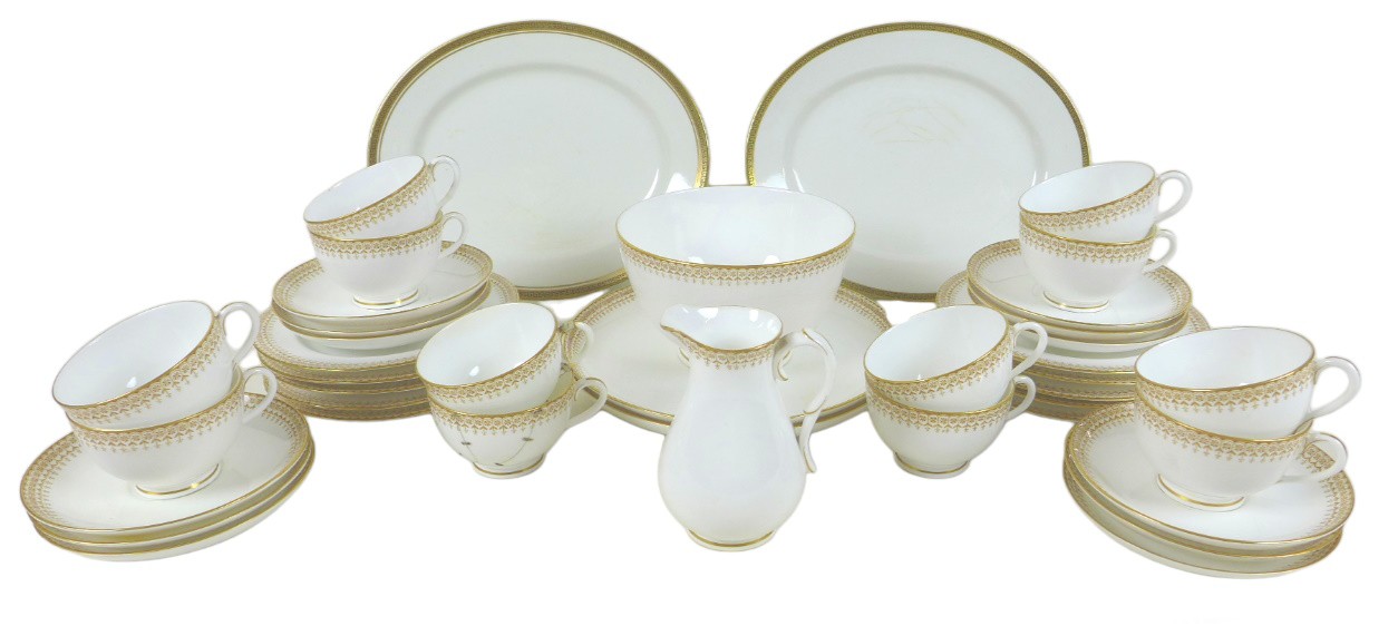 A Royal Worcester part tea service, comprising twelve teacups and saucers, ten side plates, one milk