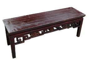 A Chinese hardwood low opium side table with carved frieze, 113 by 34 by 40cm.