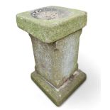 A stone bird bath, with square tapered column.