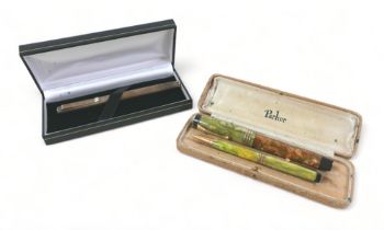 A silver plunger ink pen and a Parker fourfold pen set. Parker pen body is discoloured otherwise the