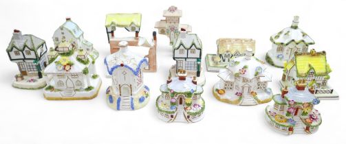 A group of sixteen Coalport bone china ornaments, each modelled as a house, including 'The