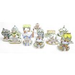 A group of sixteen Coalport bone china ornaments, each modelled as a house, including 'The