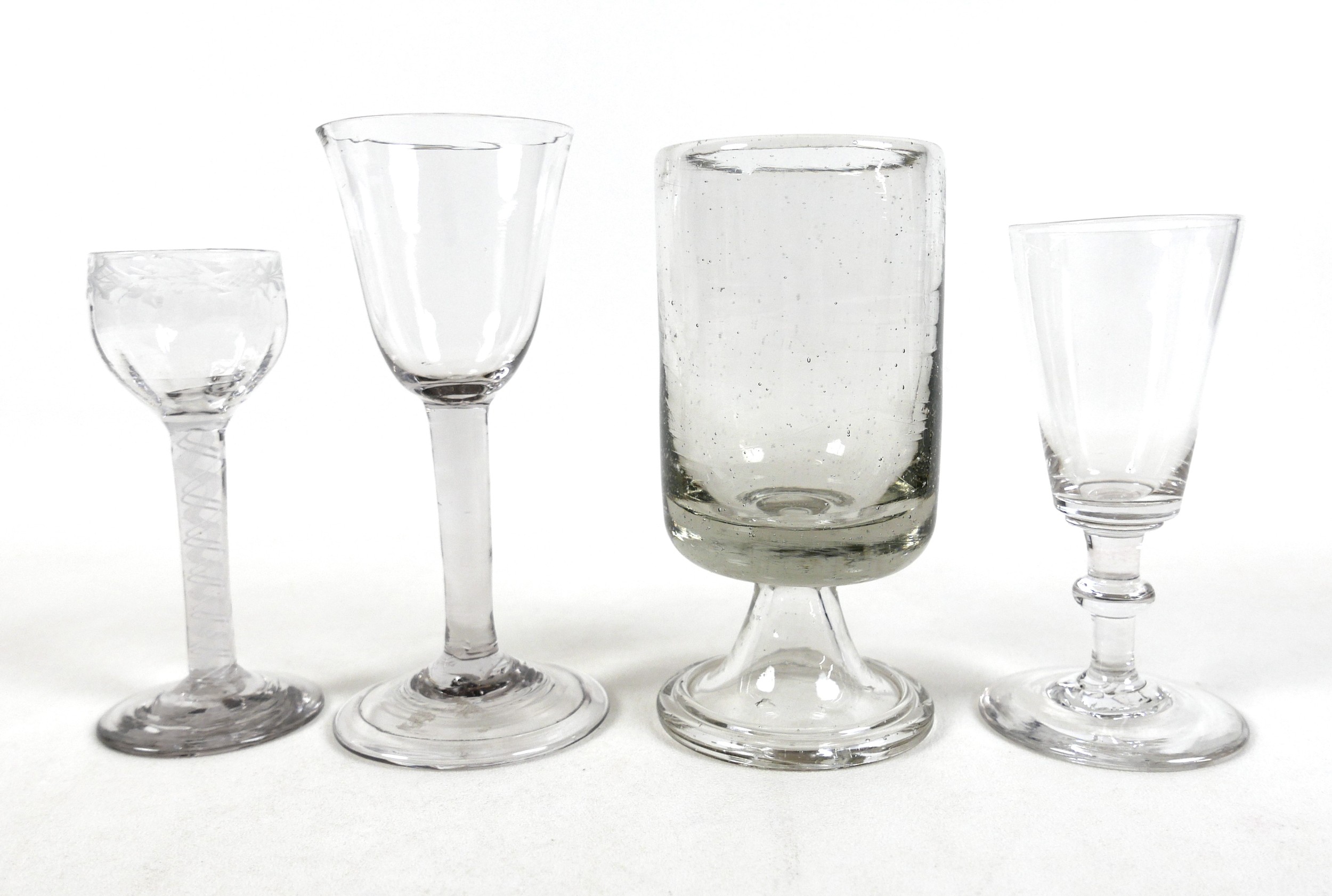 Four 18th century drinking glasses including an air twist cordial glass, largest 7.5cm diameter 16cm