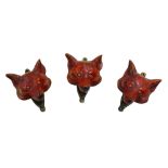 Three painted brass fox head door knockers, each 6 by 4.5 by 8cm high. (3)