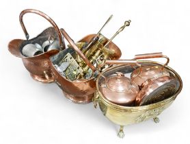 A large collection of copper and brass, including oval heraldic log basket, post horns, two shell