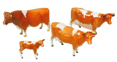 Four Beswick figurines modelled as Guernsey cows, one a/f. (4) Repair to horns on one cow.