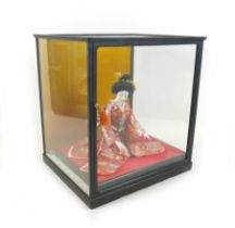 A Japanese Geisha girl doll in display case, 41 by 36 by 44cm high.