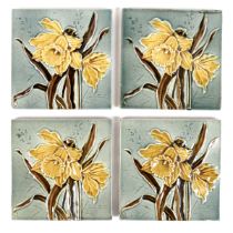 A set of four Art Nouveau tiles, by Henry Abraham Ollivant, each decorated with a daffodil, 15.5
