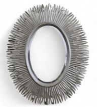 A pair of oval modern mirrors in silvery gold sunburst design