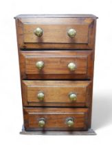 A small Victorian mahogany table top chest of four drawers, with brass knobs.