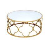 A modern mirror topped coffee table, the circular surface on a brass effect open frame base formed