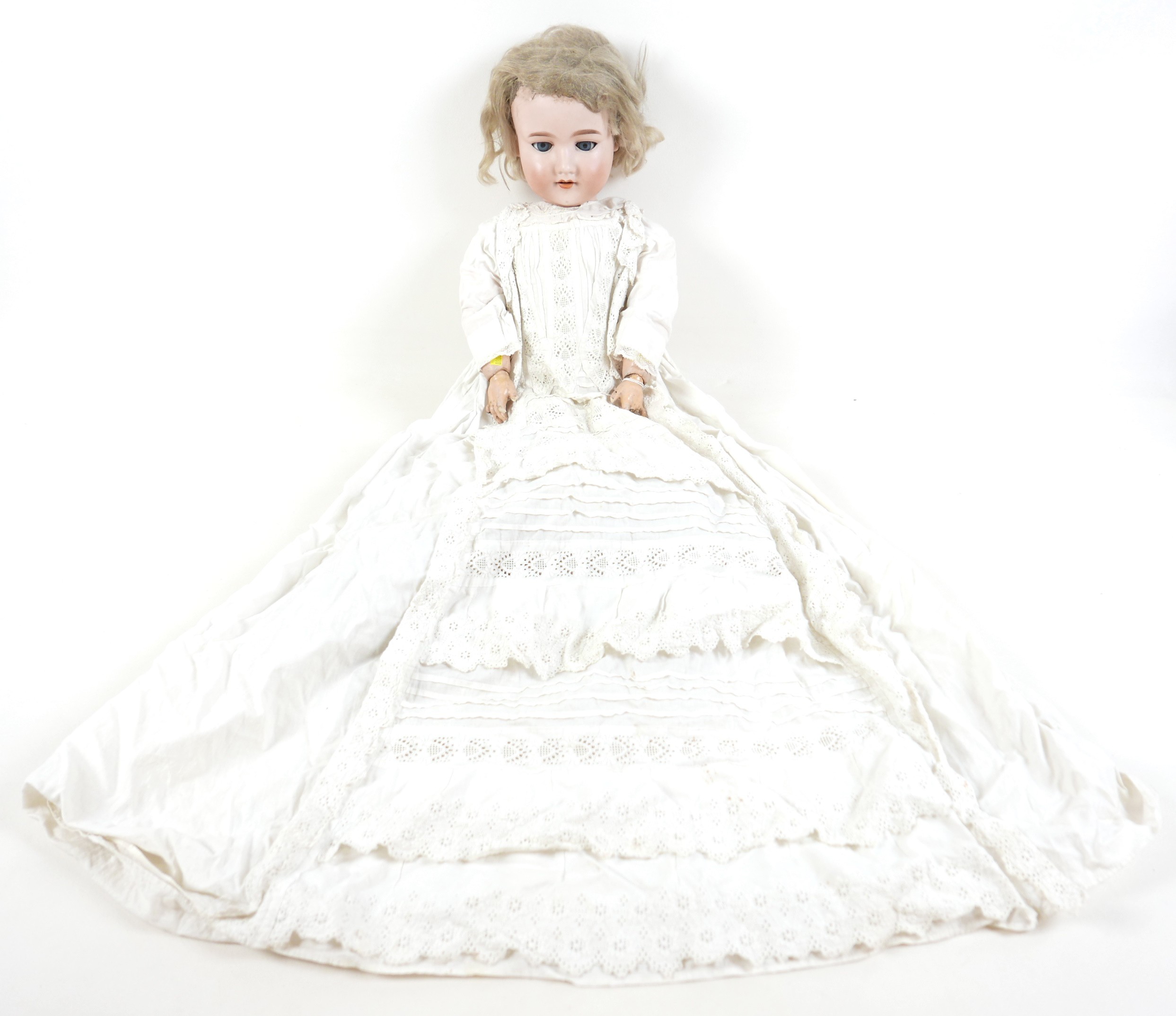 An Armand Marseille bisque porcelain headed doll with open mouth and sleepy eyes, 80cm tall. Some