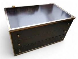 A black and brass display shelf / drawer unit with three drawers and glass shelves.