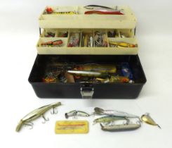 A collection of spoon and bait fishing lures, approximately 50 in total, contained in a folding