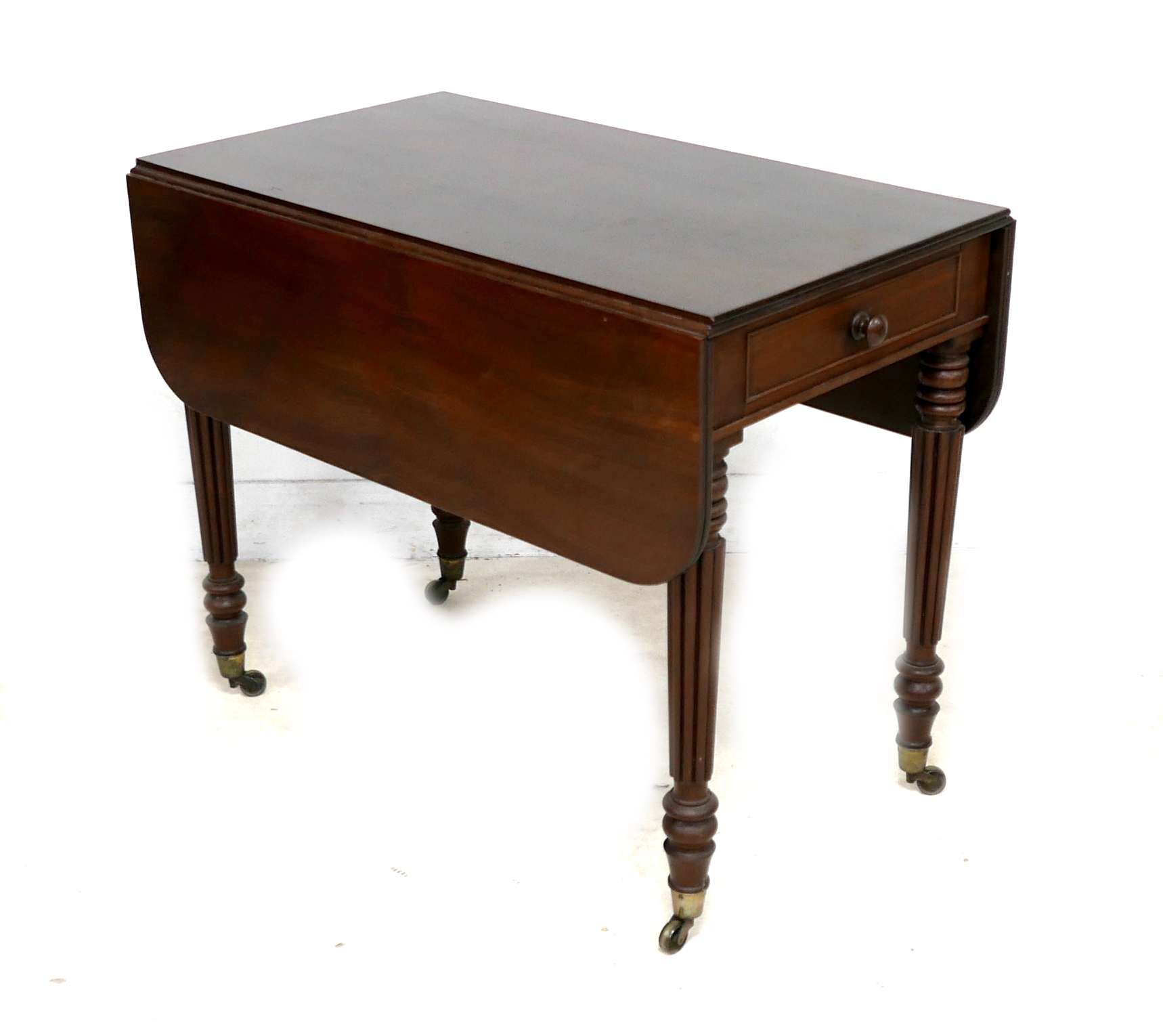 An early Victorian mahogany Pembroke table, with drop leaves, single drawer, turned and reeded