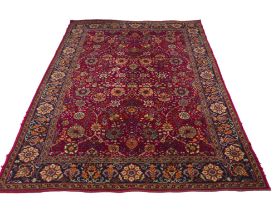 A Hamadan rug, red ground with repeating pattern to central panel, two narrow borders flanking a