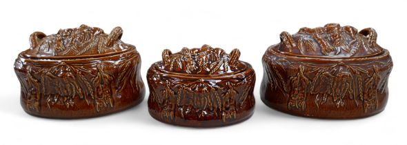 A group of three Portmeirion treacle glazed tureens and covers, decorated with game, a/f, areas of