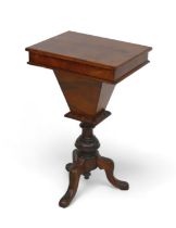 A Victorian walnut workbox on a tripod base, with a fitted interior and writing flap, 47 by 35 by