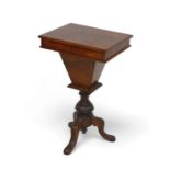 A Victorian walnut workbox on a tripod base, with a fitted interior and writing flap, 47 by 35 by