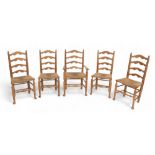 A set of five modern ladder back, rush seated dining chairs, four plus carver, by J. H. Palin, a